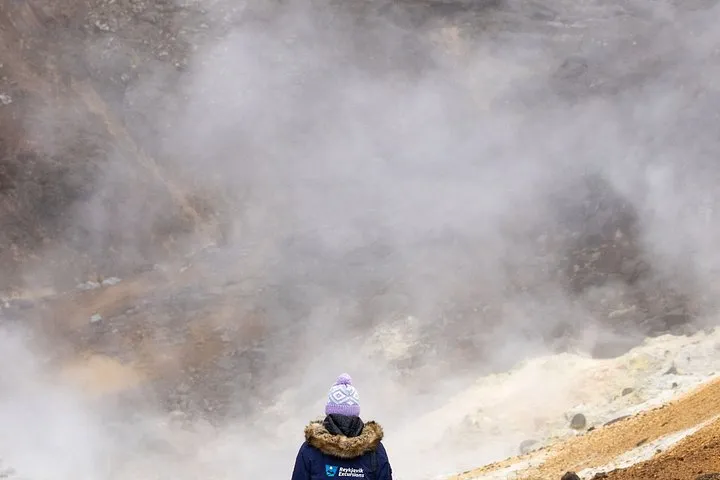 A hiking trail across dark volcanic rock near Fagradalsfjall on a Reykjavik volcano and Grindavik day tour, Iceland