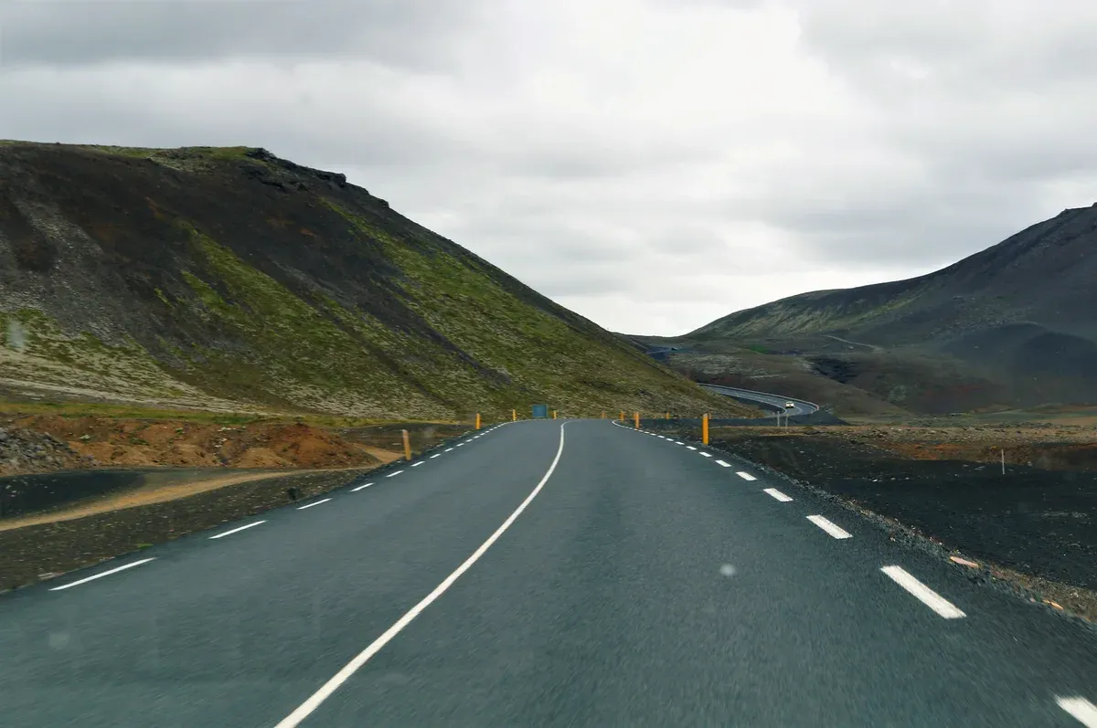 Road 427 running along the coast toward the Fagradalsfjall volcano tours trailheads, Reykjanes, Iceland
